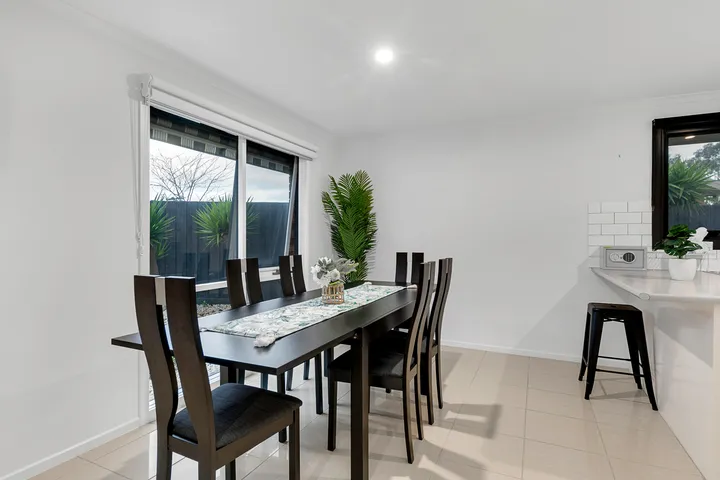 The dining area at 3 Phelan Drive, with a table seating six beside a window onto the back garden.