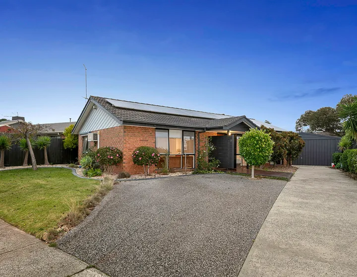 3 Phelan Drive from the street — a single-storey brick home with a tiled roof, solar panels, established front garden and a wide driveway.